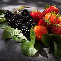 Buy canvas prints of Still life strawberries and blackberries over dark background by Laurent Renault