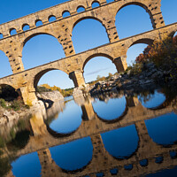 Buy canvas prints of The Pont du Gard, vertical photography tilted over blue sky. Anc by Laurent Renault