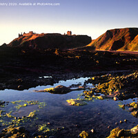 Buy canvas prints of Dunnottar  Castle near Stonehaven seen from the rocky beach below by Navin Mistry