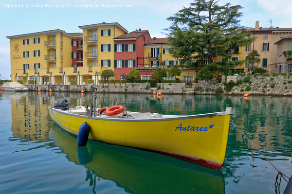  A small boat moored in the harbour of Sirmione, Lake Garda, Italy Picture Board by Navin Mistry
