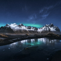 Buy canvas prints of Baby-Aurora over Stokksnes by Manuel Martin