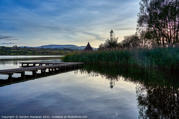 Evening at the Crannog, Llangorse Lake Picture Board by Gordon Maclaren