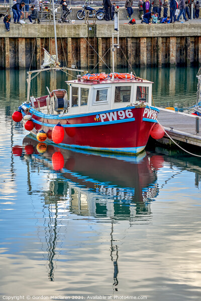 A fishing boat moored in Padstow Harbour  Picture Board by Gordon Maclaren