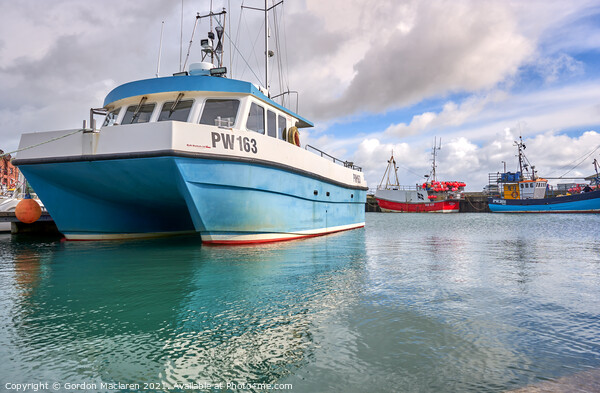 Fishing Boats moored in Padstow Harbour Picture Board by Gordon Maclaren