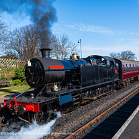 Black Steam Train Engine pulling out of a station