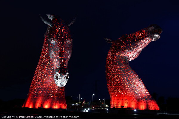 The Kelpies in red. Picture Board by Paul Clifton