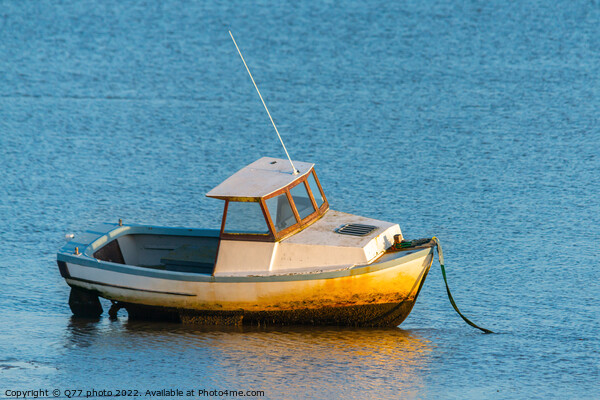 Moored boat illuminated by the rays of the setting sun on the sh Picture Board by Q77 photo