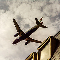Buy canvas prints of Passenger plane flying over the roofs of residenti by Q77 photo
