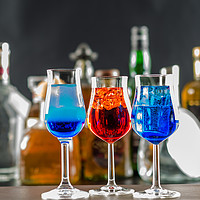 Buy canvas prints of Colorful drink on the background of bottles in ori by Q77 photo