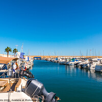 Buy canvas prints of Beautiful luxury yachts and motor boats anchored in the harbor, hot summer day and blue water in the marina, blue sky by Q77 photo