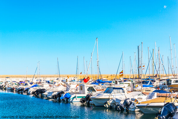 Beautiful luxury yachts and motor boats anchored in the harbor, hot summer day and blue water in the marina, blue sky Picture Board by Q77 photo