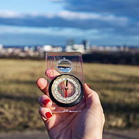 Buy canvas prints of Female hand holding glass compass, nature in backg by Josef Kubes