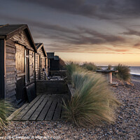 Buy canvas prints of Walberswick Beach Huts At Sunrise by David Powley