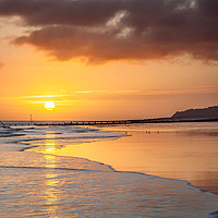 Buy canvas prints of Sunrise over Cromer beach by David Powley