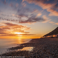 Buy canvas prints of Beach Hut Sunrise on Cromer Beach Norfolk by David Powley
