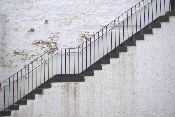 Black stairs on white wall Picture Board by Theo Spanellis