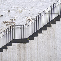 Buy canvas prints of Black stairs on white wall by Theo Spanellis
