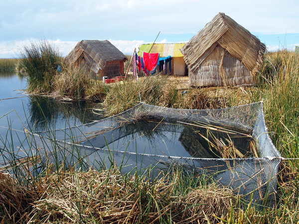 Traditional huts on Uros floating islands Picture Board by Theo Spanellis