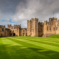 Buy canvas prints of Majestic Alnwick Castle on a Moody Autumn Day by Clive Ingram