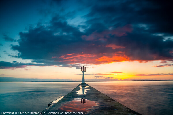 Light beacon and pier on Gironde estuary at sunset Picture Board by Stephen Rennie