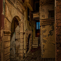 Buy canvas prints of The gruesome Moschon street in the old town of Chania at night by Stig Alenäs