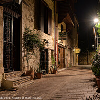 Buy canvas prints of dark alley lit by a streetlight in the old town of Chania by Stig Alenäs
