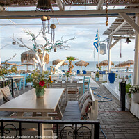 Buy canvas prints of greek tavern with blue and white tables overlooking the blue Med by Stig Alenäs