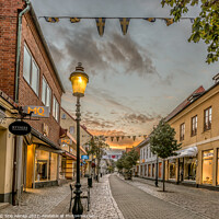 Buy canvas prints of pedestrian shopping street in Ystad with a streetlight an early  by Stig Alenäs