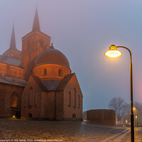 Buy canvas prints of Roskilde cathedral and a streetlight in a misty winter night  by Stig Alenäs