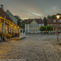 Buy canvas prints of old cobblestone square with a half-timbered hotel in the evening by Stig Alenäs