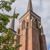 Buy canvas prints of the red brick towers of Roskilde cathedral reach up in the sky by Stig Alenäs