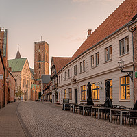 Buy canvas prints of the tower of Ribe cathedral at the end of an old c by Stig Alenäs