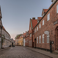 Buy canvas prints of An old cobbled street in the medieval town of Ribe by Stig Alenäs