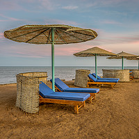 Buy canvas prints of loungers and shelters in a row at the sunset on a  by Stig Alenäs