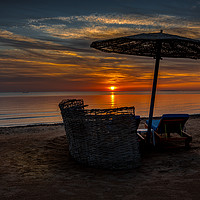 Buy canvas prints of a shelter and loungers at the beach in the sunset by Stig Alenäs