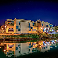Buy canvas prints of Egyptian houses at night reflecting in the lagoon by Stig Alenäs