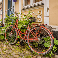 Buy canvas prints of a red retro bike leaning up against a wall with ho by Stig Alenäs