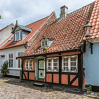 Buy canvas prints of A romantic fairytale halftimbered house on a cobbl by Stig Alenäs