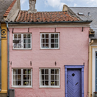 Buy canvas prints of a small house in pink with a blue door on a cobble by Stig Alenäs