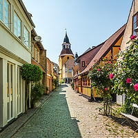 Buy canvas prints of A picturesque alleyway with cobblestones and red r by Stig Alenäs