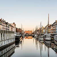 Buy canvas prints of Sunrise over the calm water at Nyhavn harbor  in C by Stig Alenäs