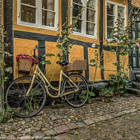 Buy canvas prints of yellow bike leaning against a yellow half-timbered by Stig Alenäs