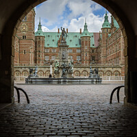 Buy canvas prints of Entrance through a dark gate under an arch to Frederiksborg cast by Stig Alenäs