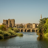 Buy canvas prints of Egyptian town in the sunset , a view from a cruise on the Nile by Stig Alenäs