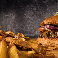 Buy canvas prints of Delicious Cheeseburger with French fries by Erik Lattwein
