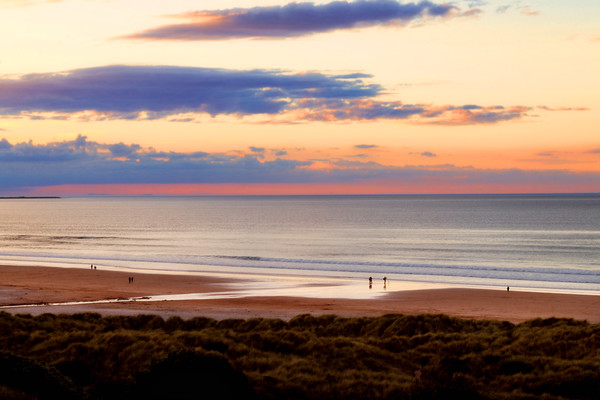 Bamburgh beach at sunset Picture Board by Simon Marlow