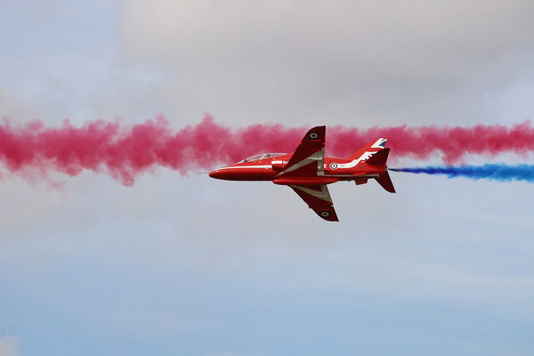 Red Arrows through blue and red smoke Picture Board by Simon Marlow