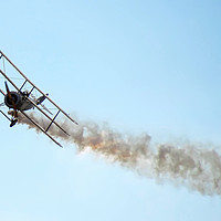 Buy canvas prints of Sopwith Triplane flying with smoke behind by Simon Marlow