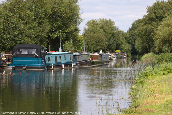 Barges moored on the Kennet and Avon Canal Picture Board by Simon Marlow