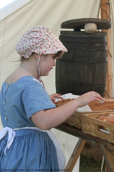 Woman baking bread, Civil War Reenactment; girl at counter Picture Board by Arun 
